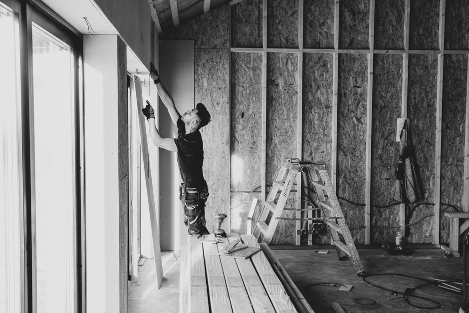 Contractor carefully installing custom kitchen cabinets