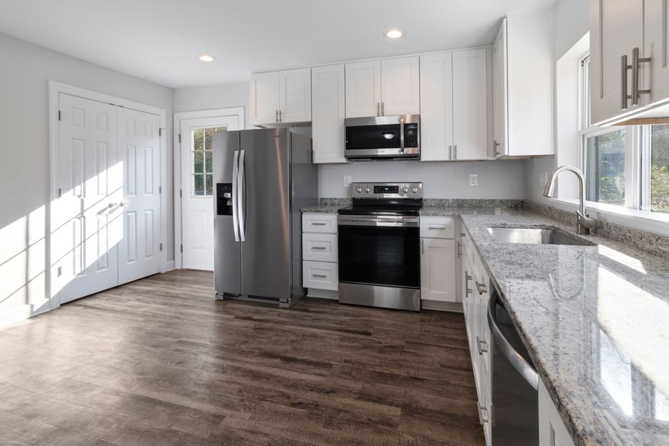 A modern, fully renovated custom kitchen with elegant cabinets and lighting